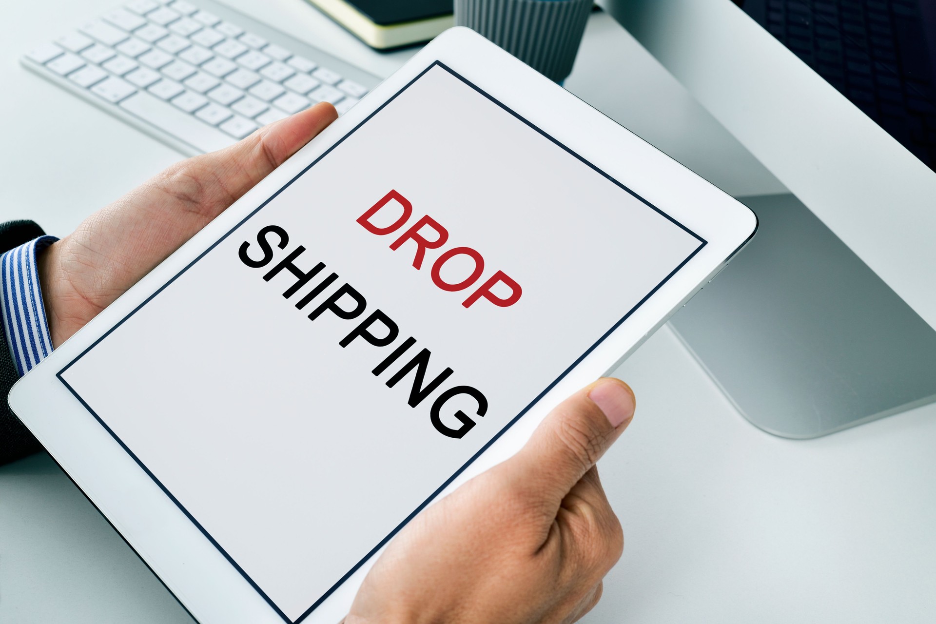 businessman with a tablet with the text drop shipping